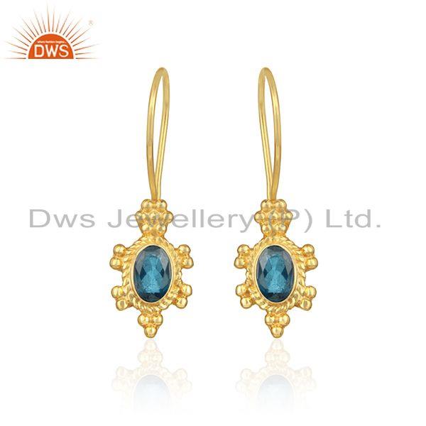 Textured earring in yellow gold on silver with london blue topaz
