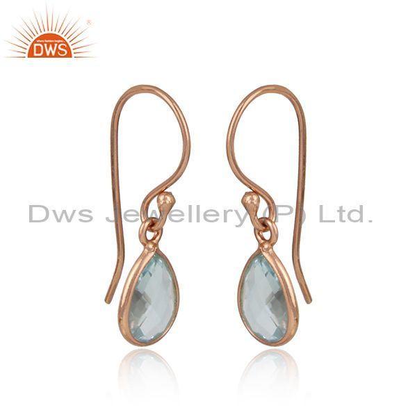 Rose gold on silver bezel set drop earrings with natural blue topaz