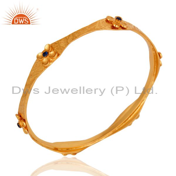 Supplier of 22 carat yellow gold on textured design bangle blue cubic zirconia
