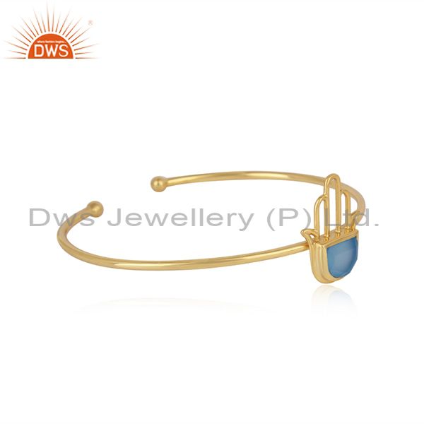 Designer hamsa cuff in yellow gold on silver with blue chalcedony