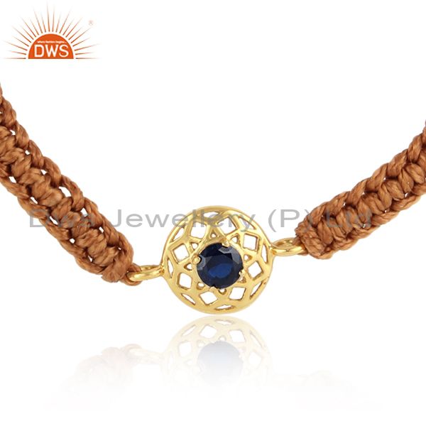 Floral designer cord bracelet in gold on silver and blue sapphire cz