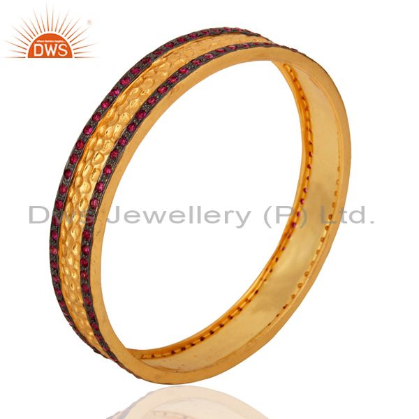 Wholesalers of 18k yellow gold plated ruby color white zircon textured bangle