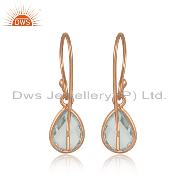 Rose gold on silver bezel set drop earrings with natural blue topaz