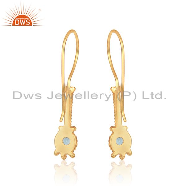 Designer long earring in yellow gold on silver with blue topaz
