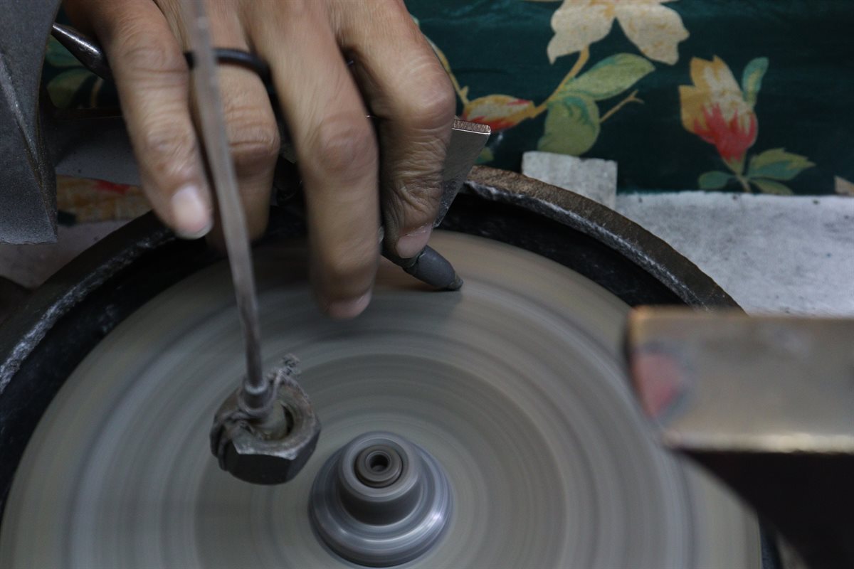 Faceting a gemstone on a faceting machine at DWS Jewellery, Jaipur