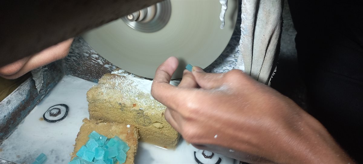 Pre-forming turquoise on a grinding wheel at DWS Jewellery, Jaipur